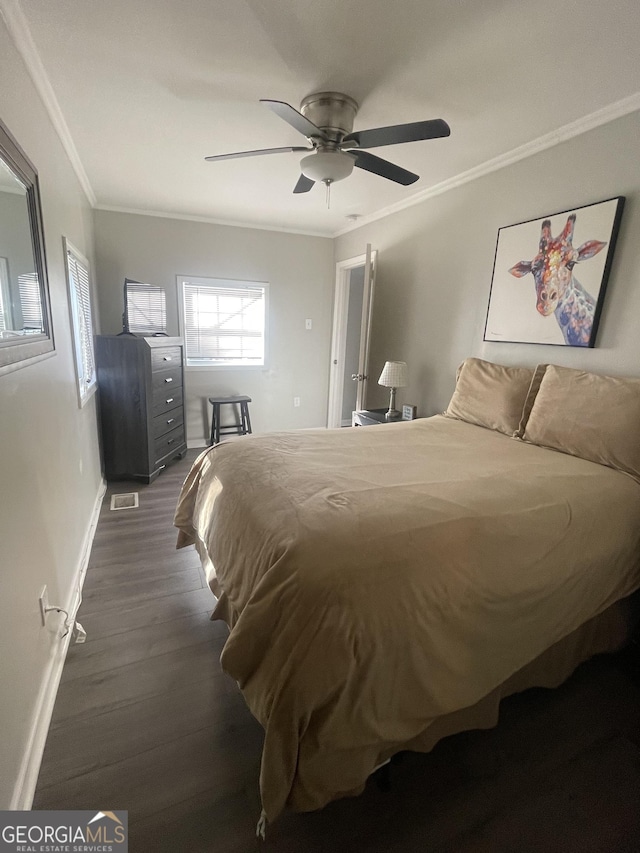 bedroom with ceiling fan, dark hardwood / wood-style flooring, and ornamental molding