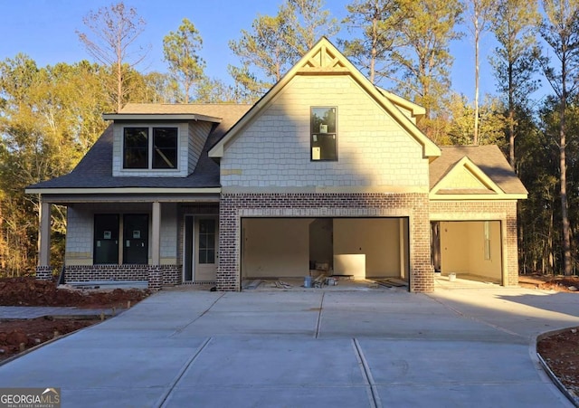 view of front of home featuring a porch and a garage