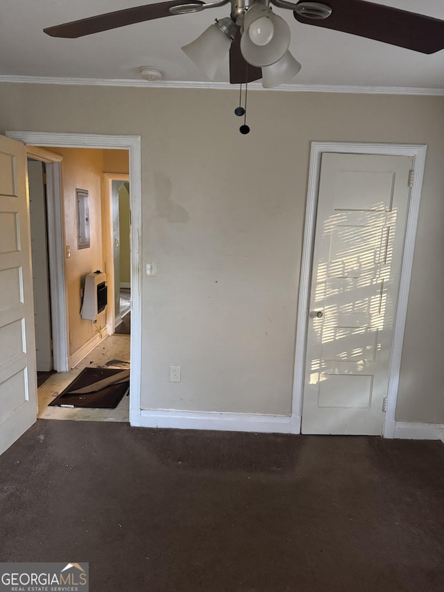 spare room with ceiling fan, crown molding, and heating unit