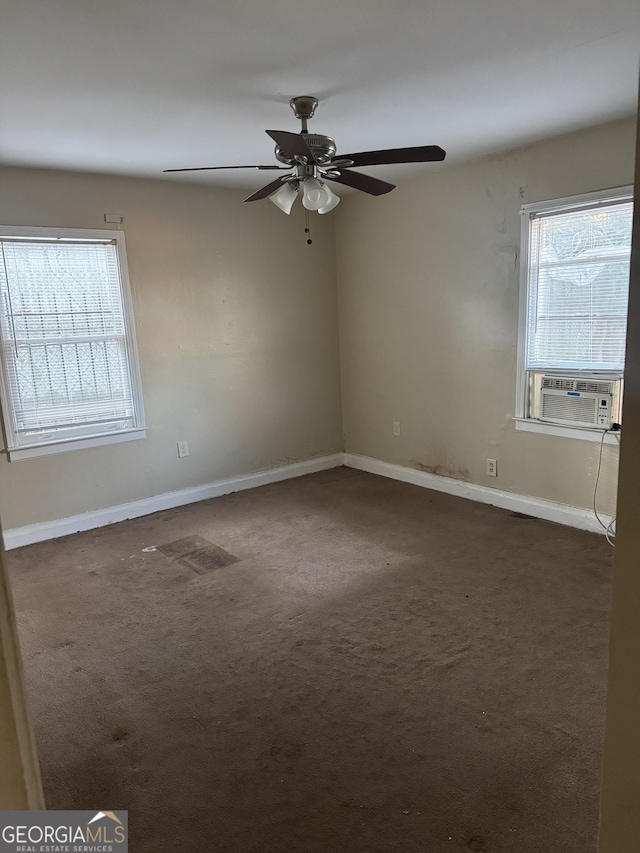 carpeted spare room featuring plenty of natural light, cooling unit, and ceiling fan