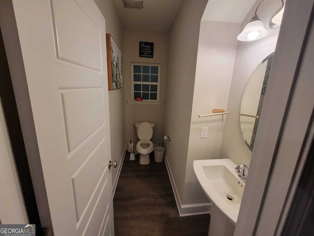 bathroom with sink, hardwood / wood-style floors, and toilet