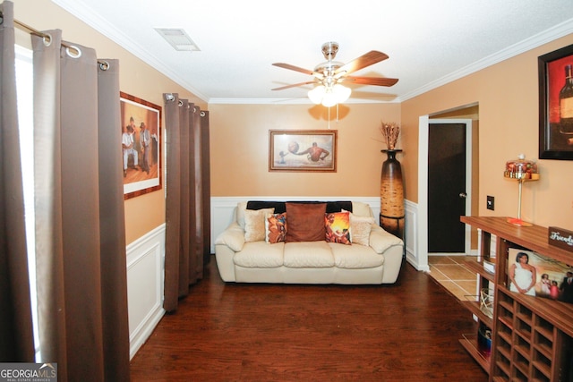 living room featuring ceiling fan, ornamental molding, and dark wood-type flooring