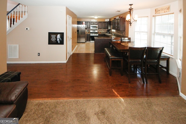 dining room featuring hardwood / wood-style flooring, an inviting chandelier, and sink