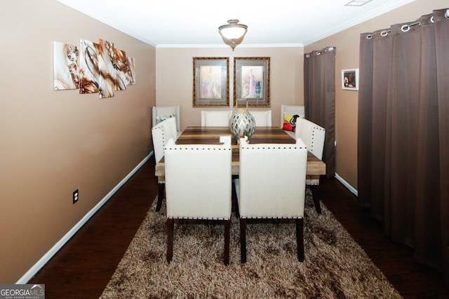 dining space with dark hardwood / wood-style floors and ornamental molding