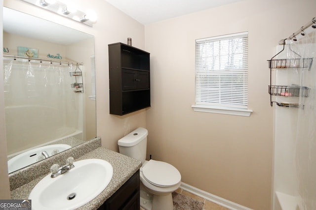 bathroom with tile patterned floors, vanity, toilet, and walk in shower