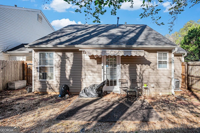 rear view of property featuring a patio area and central air condition unit