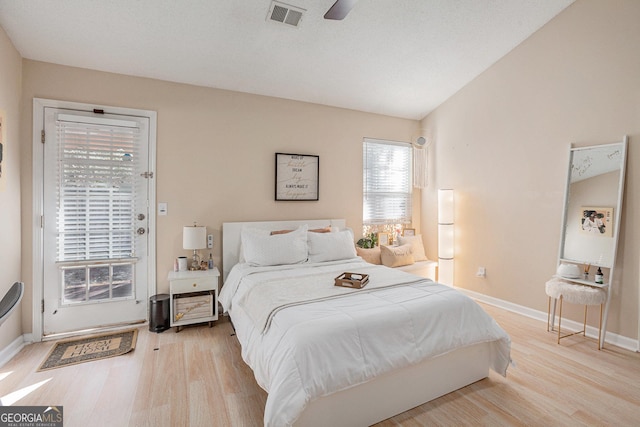 bedroom featuring light hardwood / wood-style flooring, ceiling fan, and lofted ceiling