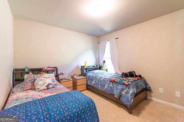 bedroom featuring light colored carpet