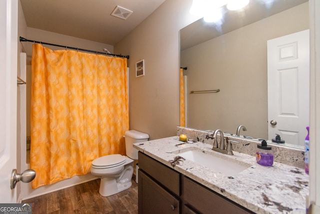 full bathroom with hardwood / wood-style flooring, vanity, toilet, and shower / bathtub combination with curtain