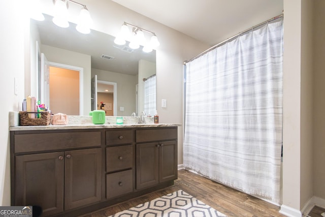 bathroom with vanity and wood-type flooring