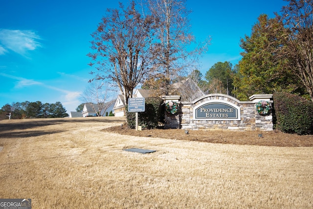 community / neighborhood sign with a lawn