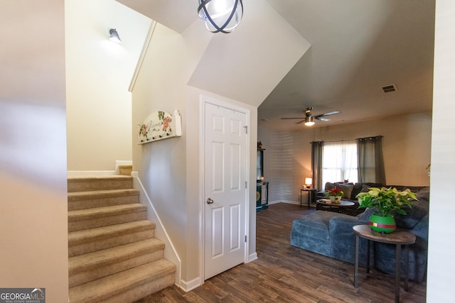 stairway with hardwood / wood-style floors and ceiling fan