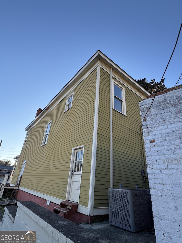 view of side of home with cooling unit