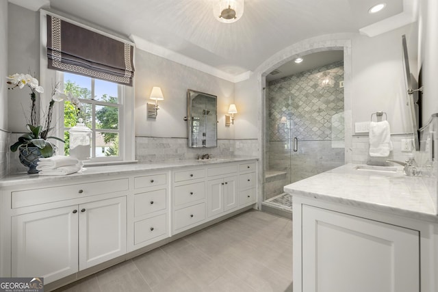 bathroom featuring tile patterned flooring, vanity, and an enclosed shower