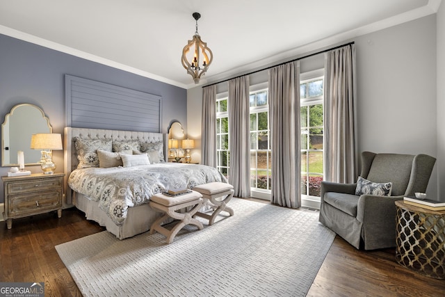 bedroom with a notable chandelier, dark hardwood / wood-style flooring, and crown molding