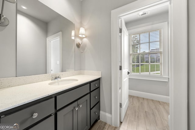 bathroom with vanity and hardwood / wood-style flooring