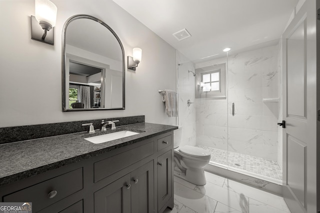 bathroom featuring toilet, an enclosed shower, and vanity