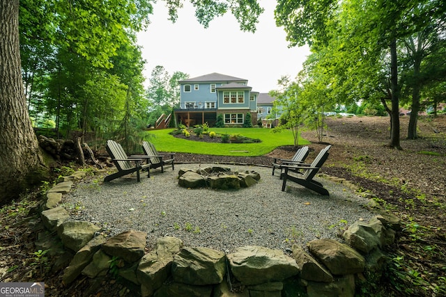 view of yard with a deck and an outdoor fire pit