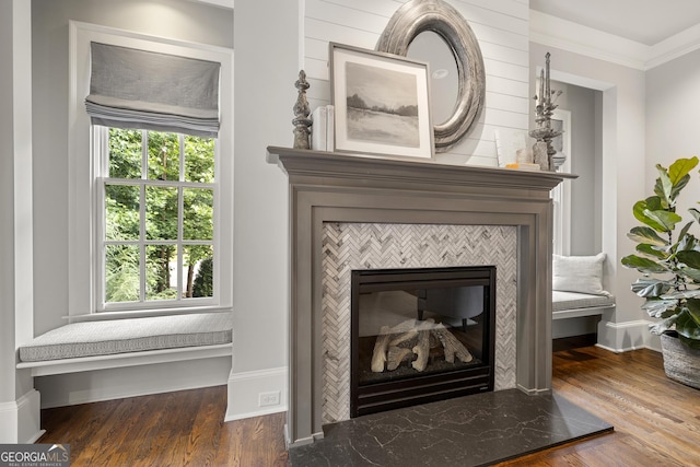 room details featuring crown molding, a fireplace, and hardwood / wood-style floors