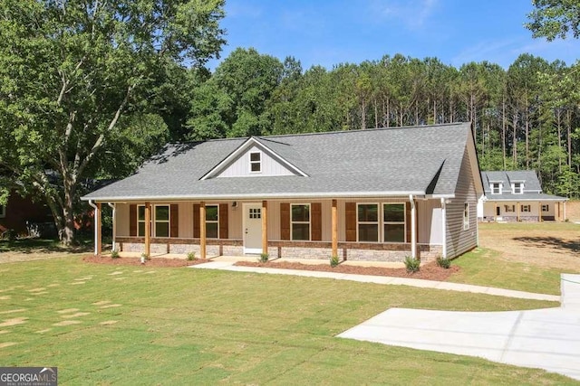 view of front of home with a porch and a front yard