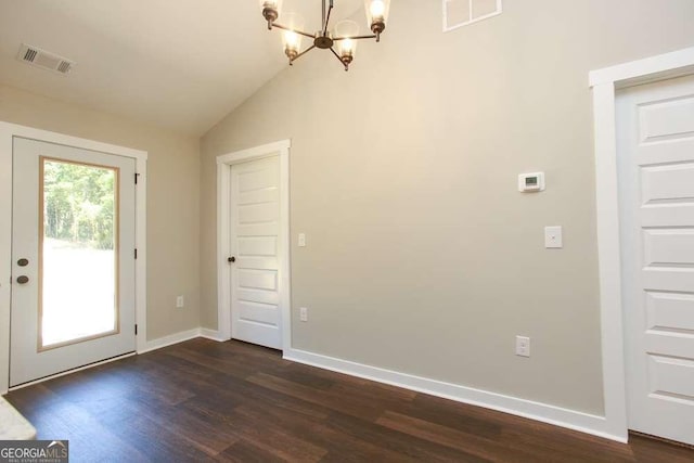 interior space featuring a notable chandelier, dark wood-type flooring, and vaulted ceiling