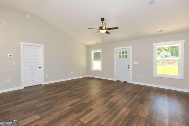 unfurnished living room with lofted ceiling, dark wood-type flooring, and a healthy amount of sunlight