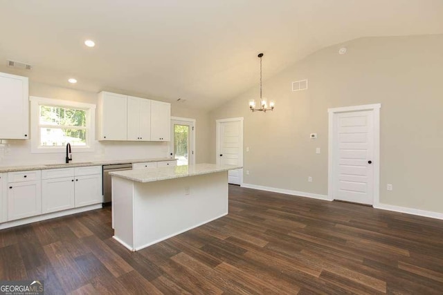 kitchen featuring white cabinetry, dark hardwood / wood-style floors, pendant lighting, lofted ceiling, and a kitchen island