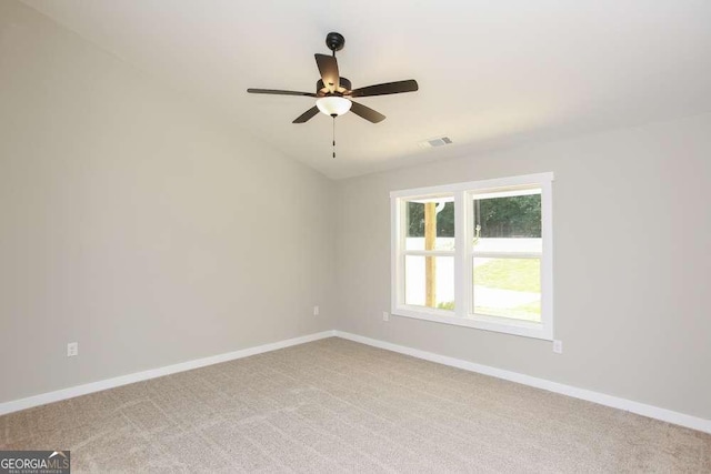 carpeted empty room featuring ceiling fan and lofted ceiling