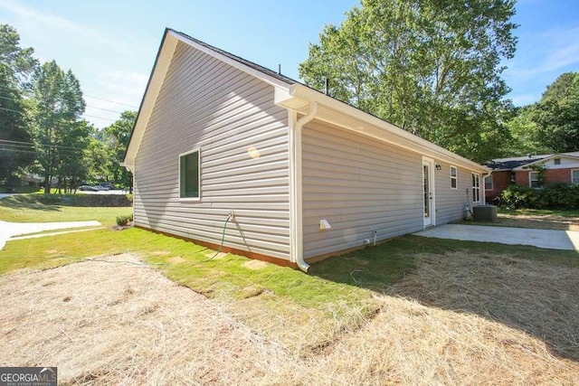 view of side of home with a patio