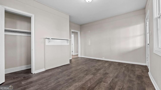 unfurnished bedroom featuring dark hardwood / wood-style floors and a closet