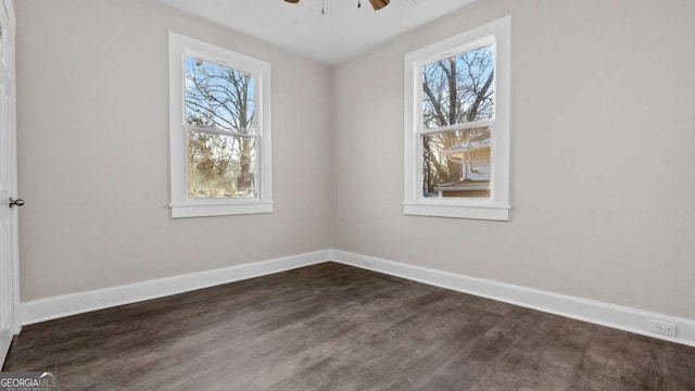 unfurnished room with plenty of natural light, dark hardwood / wood-style floors, and ceiling fan