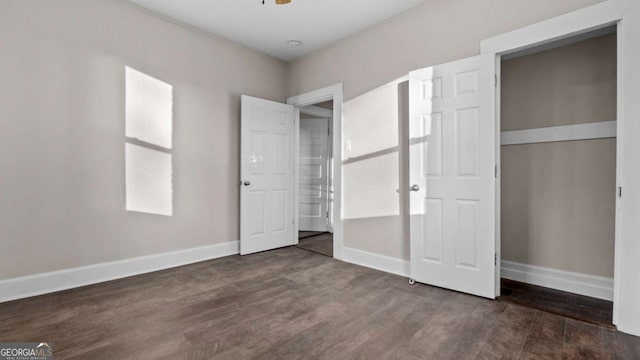 unfurnished bedroom featuring dark hardwood / wood-style floors