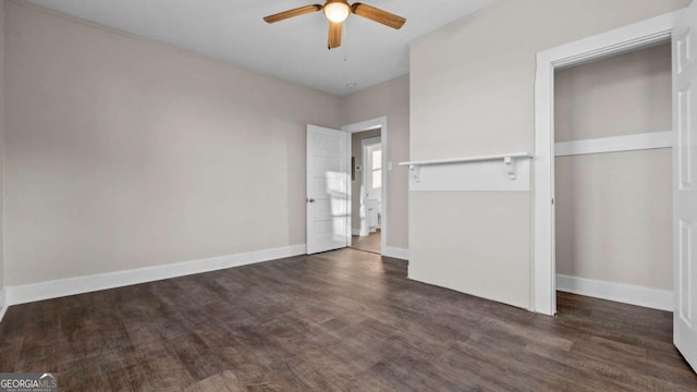 unfurnished bedroom with a closet, dark hardwood / wood-style floors, and ceiling fan