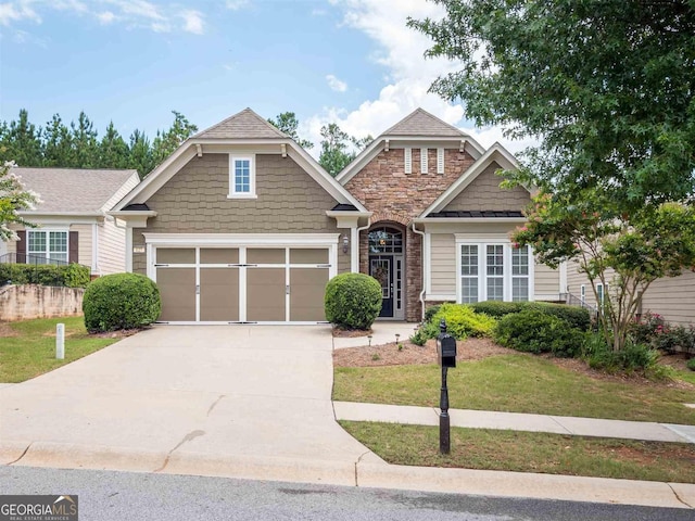 craftsman-style home featuring a garage and a front yard