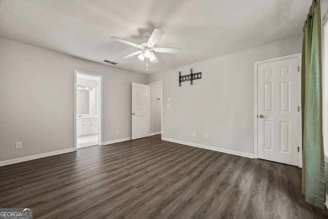unfurnished bedroom featuring dark wood-style floors, visible vents, and baseboards