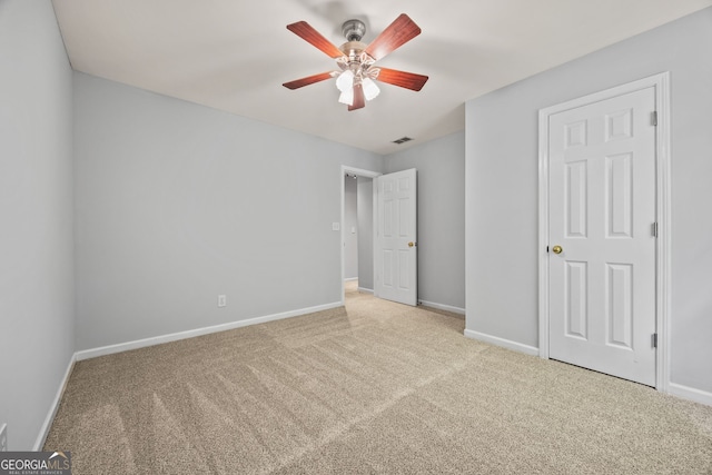 unfurnished bedroom with ceiling fan, baseboards, visible vents, and carpet