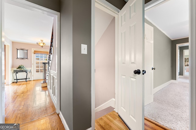 hallway with light hardwood / wood-style floors