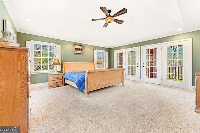 carpeted bedroom featuring ceiling fan, a raised ceiling, crown molding, and access to outside