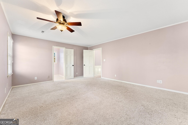 carpeted spare room featuring ceiling fan