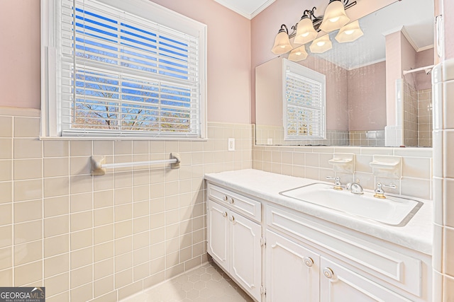 bathroom featuring vanity, tile patterned floors, tile walls, and crown molding