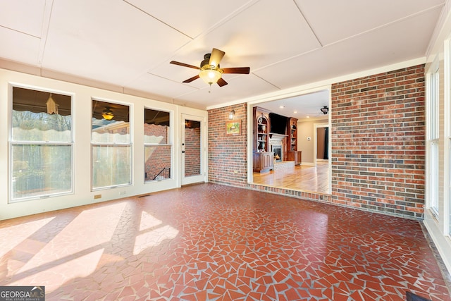 interior space with ceiling fan