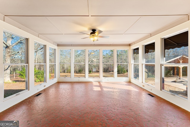 unfurnished sunroom with ceiling fan