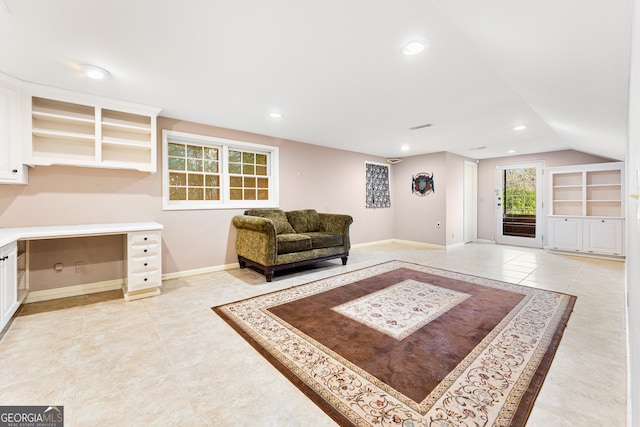 living room featuring lofted ceiling and light tile patterned floors