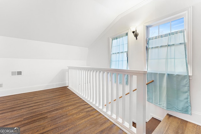 hallway with dark hardwood / wood-style flooring and vaulted ceiling