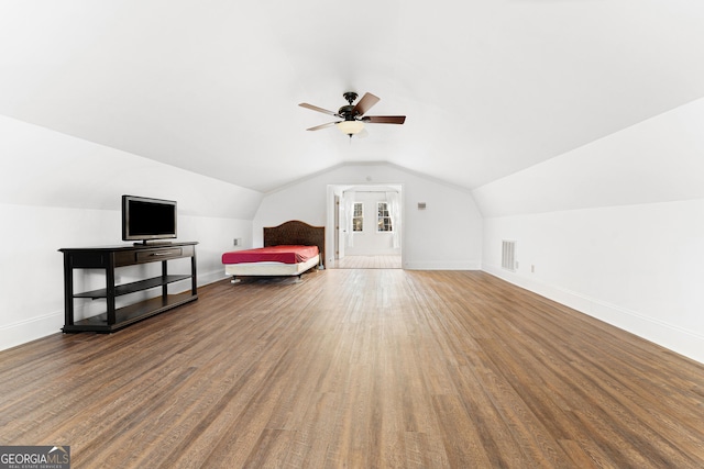 bedroom with ceiling fan, vaulted ceiling, and hardwood / wood-style flooring