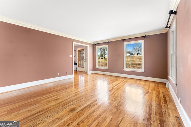 unfurnished room featuring crown molding and light wood-type flooring