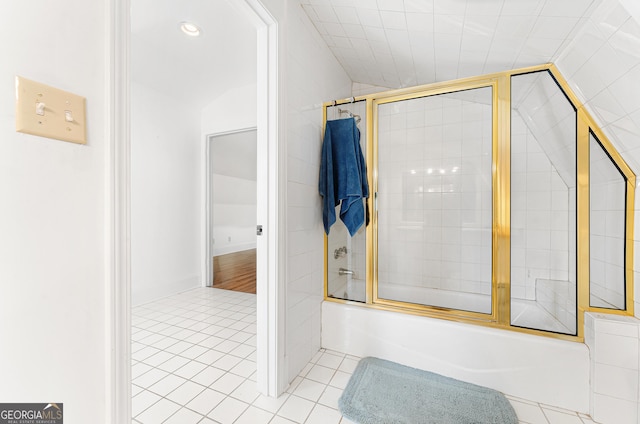 bathroom with tile patterned floors, lofted ceiling, and bath / shower combo with glass door