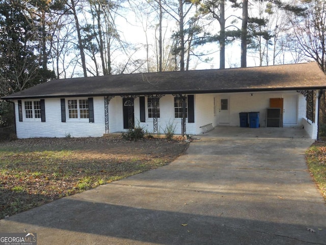 ranch-style home featuring a carport