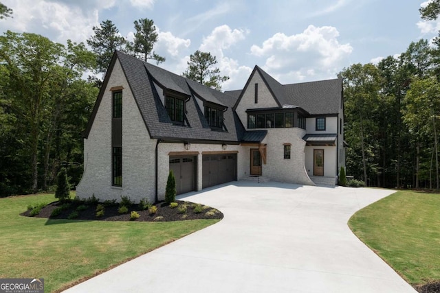 view of front of house featuring a garage and a front lawn