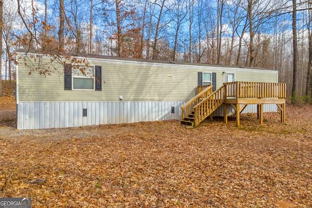 back of house with a wooden deck